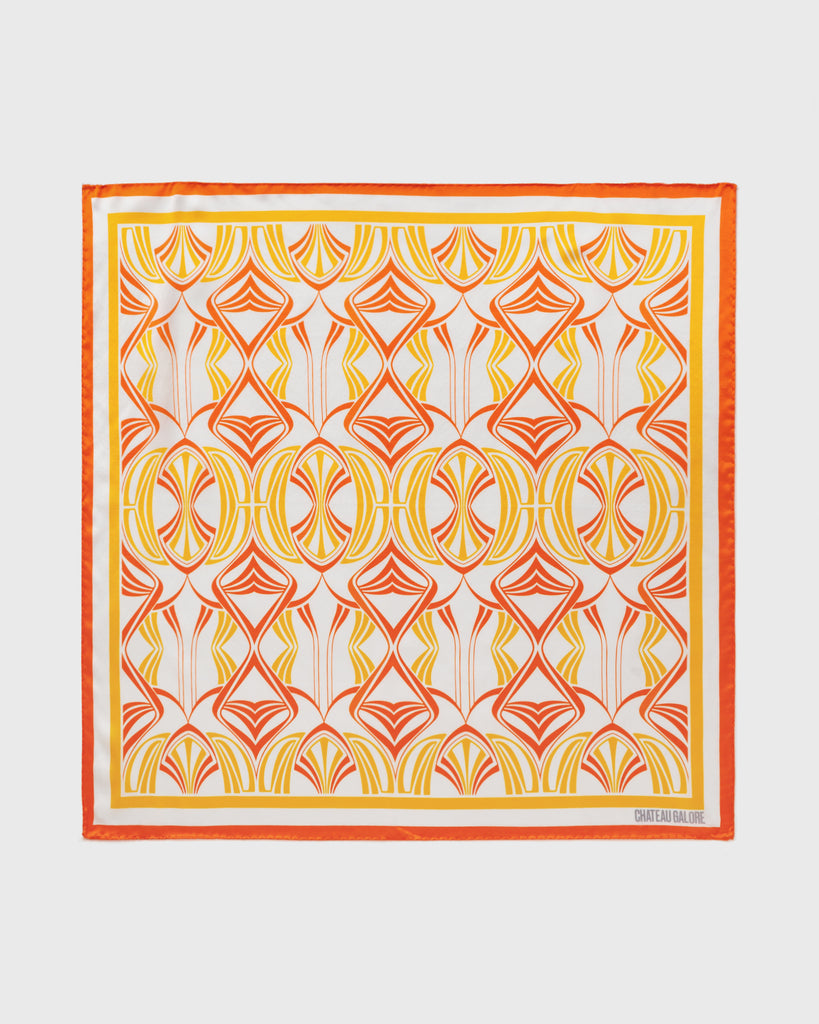 Product shot of a silk scarf printed with a dusky pink and forest green art nouveau pattern